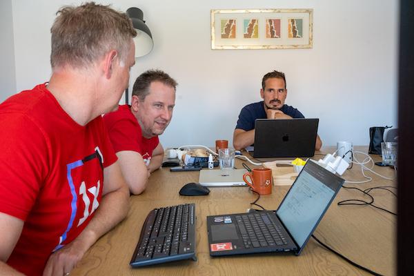 Dominique De Cooman presents to Christoph Breidert and Gábor Hojtsy the financial report