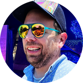 Eric Davila smiling in mirrored shades and a cap